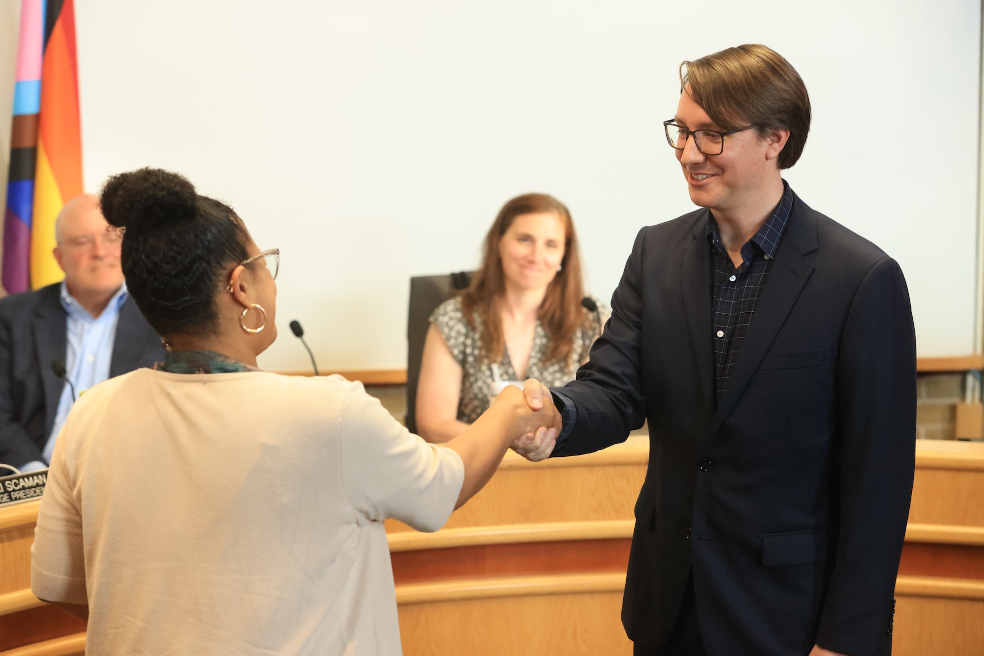Trustee Eder shaking hands with Clerk Waters